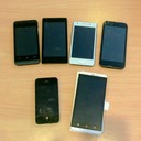 A picture of 5 cheap Android phones next to my iPhone 4s for size comparison